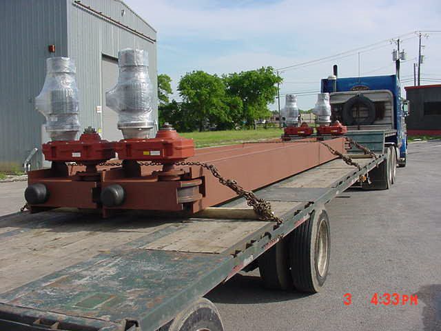 Custom end trucks loaded on flatbed trailer